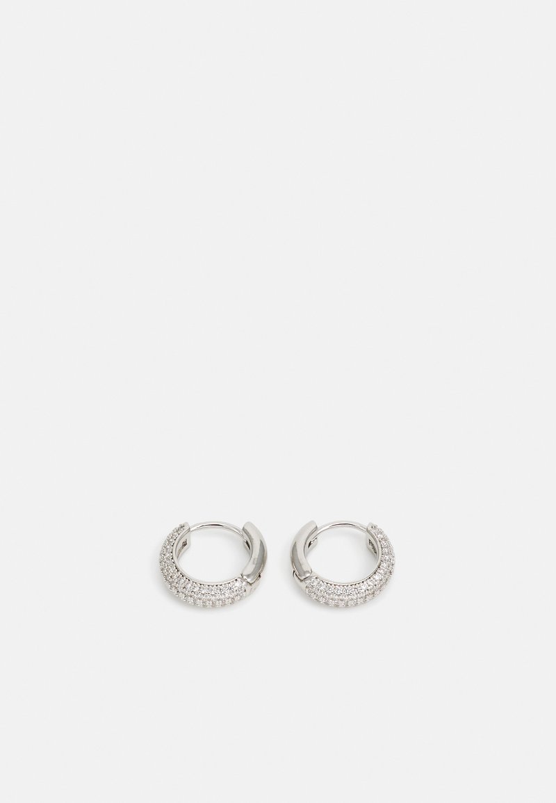 Silver hoop earrings featuring a glittering band of clear rhinestones along the front. Smooth finish with a rounded design and hinge closure.