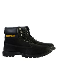 Black leather work boots with mid-top design, lace-up front, padded collar, and rubber sole featuring Caterpillar logo in yellow.