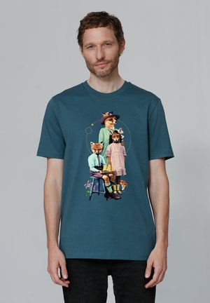 T-shirt en coton teal avec un graphique coloré de renards anthropomorphes et d'enfants en tenue rétro, entourés d'éléments floraux.