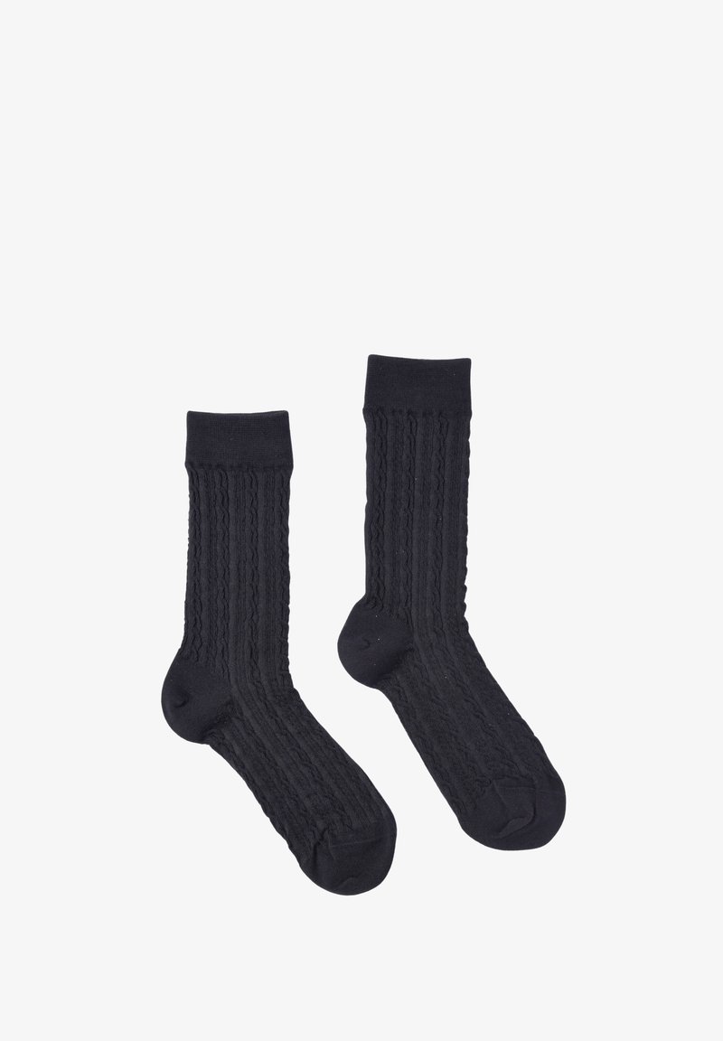 Calze di cotone nere con una texture a coste verticali e talloni rinforzati. Lunghezza a metà polpaccio con un orlo liscio, progettate per comfort e vestibilità.