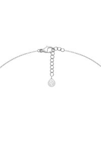 Silver chain bracelet with a lobster claw clasp, featuring an adjustable length chain and a small circular charm with a symbol.
