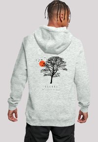 Gray hoodie featuring a black tree graphic, an orange sun, and birds. Texture is smooth with a relaxed fit design. Text reads "ESCAPE."