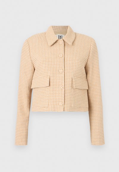 Veste courte beige et blanche à motif pied-de-poule, manches longues, boutons sur le devant, col à revers et deux poches à rabat à l'avant.