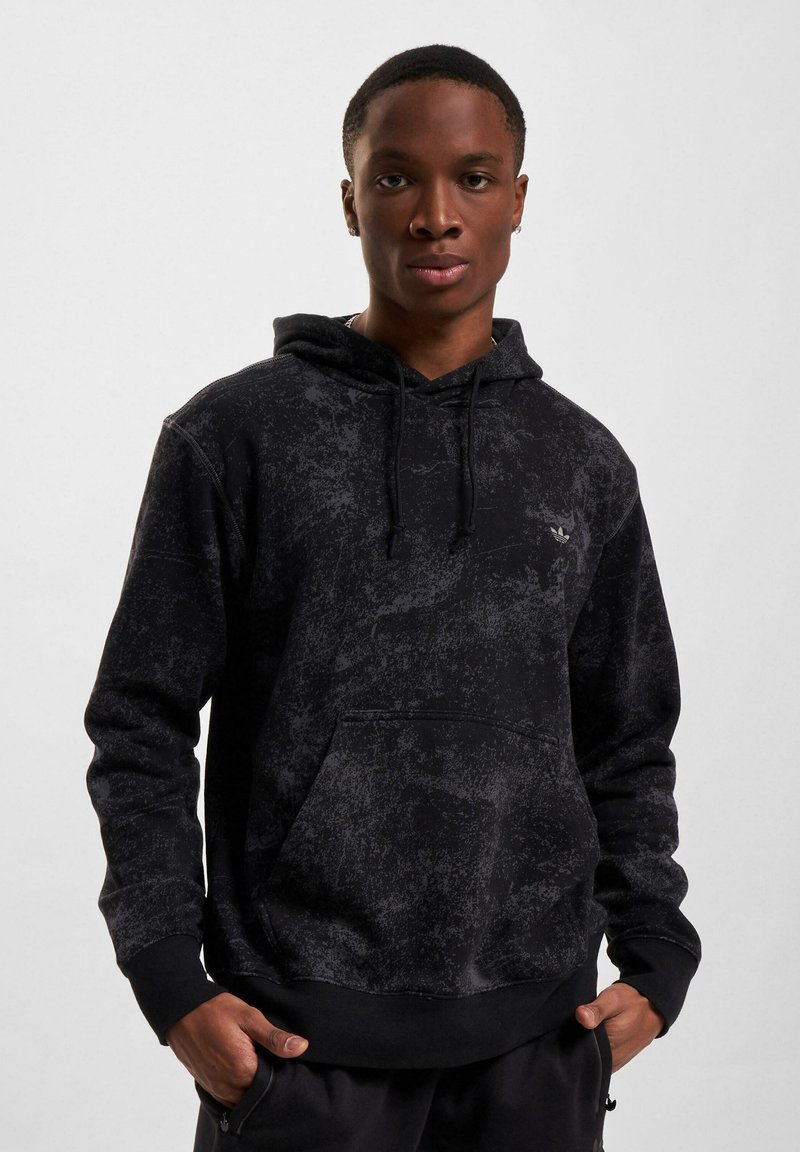 Schwarzer Hoodie mit strukturiertem, gemustertem Design, Kordelzugkapuze und Kängurutasche. Verfügt über gerippte Bündchen und Saum sowie einen leichten Stoff.