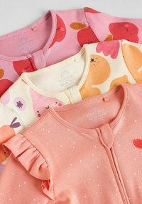 Three baby bodysuits in pink, cream, and coral. Each features distinct patterns: apples, fruits, and ruffled sleeves with white polka dots.
