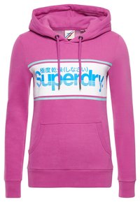 Sudadera con capucha rosa con parte frontal blanca, texto azul "Superdry", cordones, bolsillo canguro y puños y bajo acanalados.