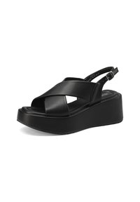Sandali platform neri con cinturini in pelle incrociati e design slingback. Presentano una suola spessa per un'altezza e stabilità aggiuntive.