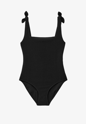 Maillot de bain une pièce noir avec tissu texturé et bretelles nouées aux épaules.
