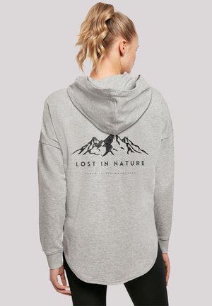 Gray hooded sweatshirt with a rounded hem, featuring a mountain graphic and text "LOST IN NATURE" on the back. Soft fabric texture.