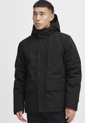 Black insulated jacket with a hood, featuring a zippered front, snap buttons, and two front pockets. Smooth texture, minimalist design.