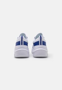 White sneakers with blue accents, featuring a smooth synthetic upper, rubber sole, and two-tone heel striping for contrast.