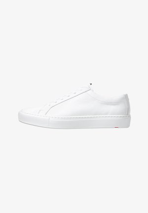 White leather sneaker with a rounded toe, flat rubber sole, and minimalistic lace-up design. Smooth texture, no visible patterns or accents.