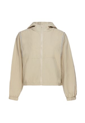 Beige capuchonjas met rits aan de voorkant, elastische manchetten en twee voorzakken, getoond op een witte achtergrond.