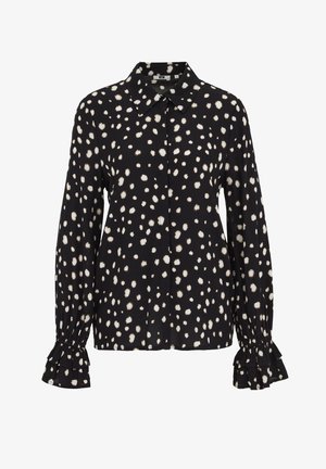 Fekete blúz fehér pöttyös mintával. Galléros nyakkivágással és fodros mandzsettákkal a hosszú ujjain.