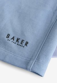 Modrá bavlněná tkanina s hladkou texturou, na které je výrazně zobrazeno černé logo "BAKER by TED BAKER". Žádné další vzory.