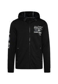 Sudadera con cremallera negra, con capucha, que presenta gráficos impresos, cremallera frontal y bolsillos laterales. Confeccionada en una tela suave, con puños acanalados.