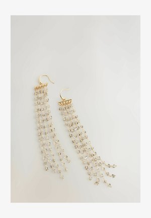 Zlaté náušnice s mnoha prameny průhledných korálků, kaskádový design a háčkovým zapínáním. Korálky odrážejí světlo pro ještě větší lesk.