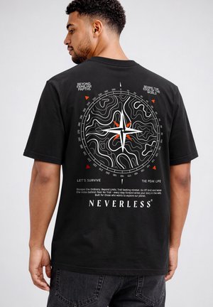 Man wearing black t-shirt with a white and orange compass and contour map design and motivational text on the back.