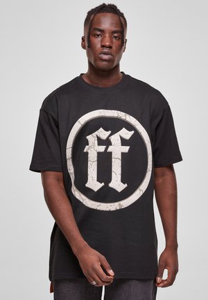 Black oversized t-shirt made of cotton, featuring a large distressed white circular logo with "ff" in the center. Short sleeves, crew neck.