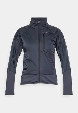 Giacca sportiva blu navy con colletto alto, zip a lunghezza totale e tasca sul petto. Realizzata in un materiale leggero e liscio con dettagli a contrasto sulle maniche.