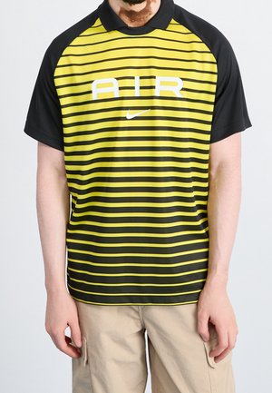 Yellow and black striped Nike polo shirt with a black collar. Features white "AIR" text across the chest and short sleeves.