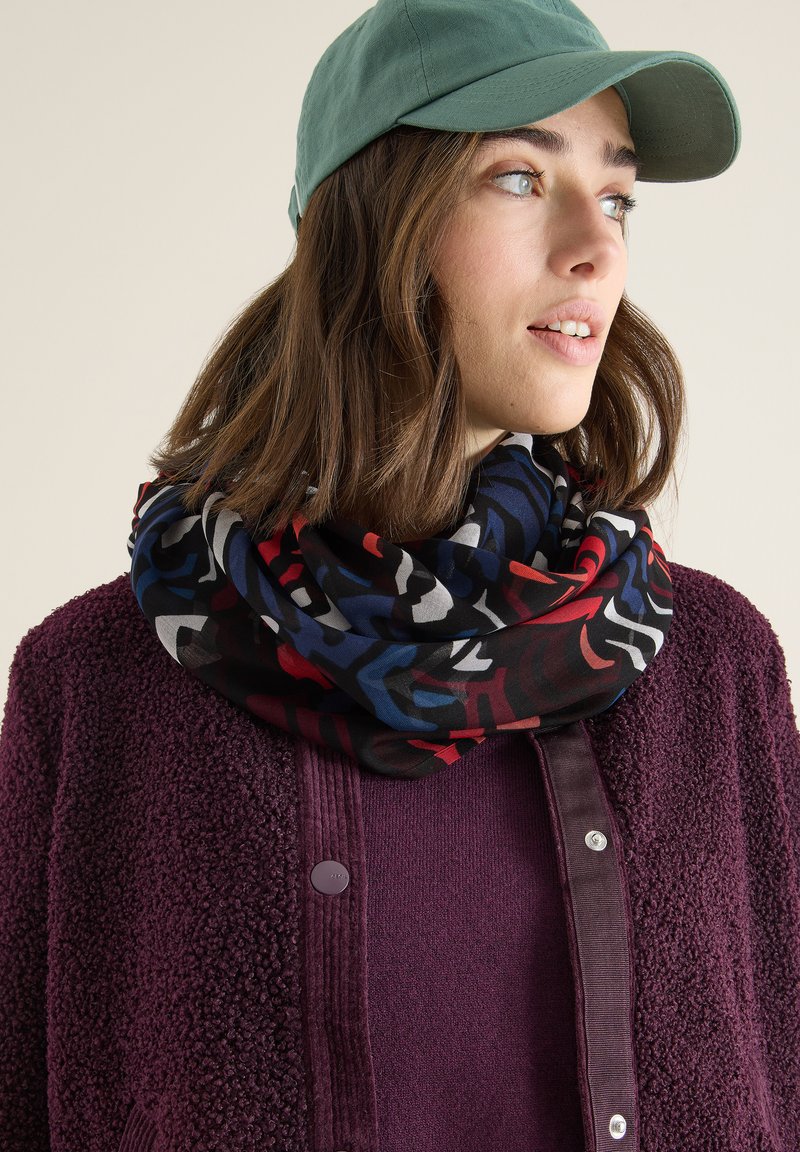 Tube scarf in a colorful abstract pattern featuring black, red, blue, and white. Made of soft fabric with a smooth texture.