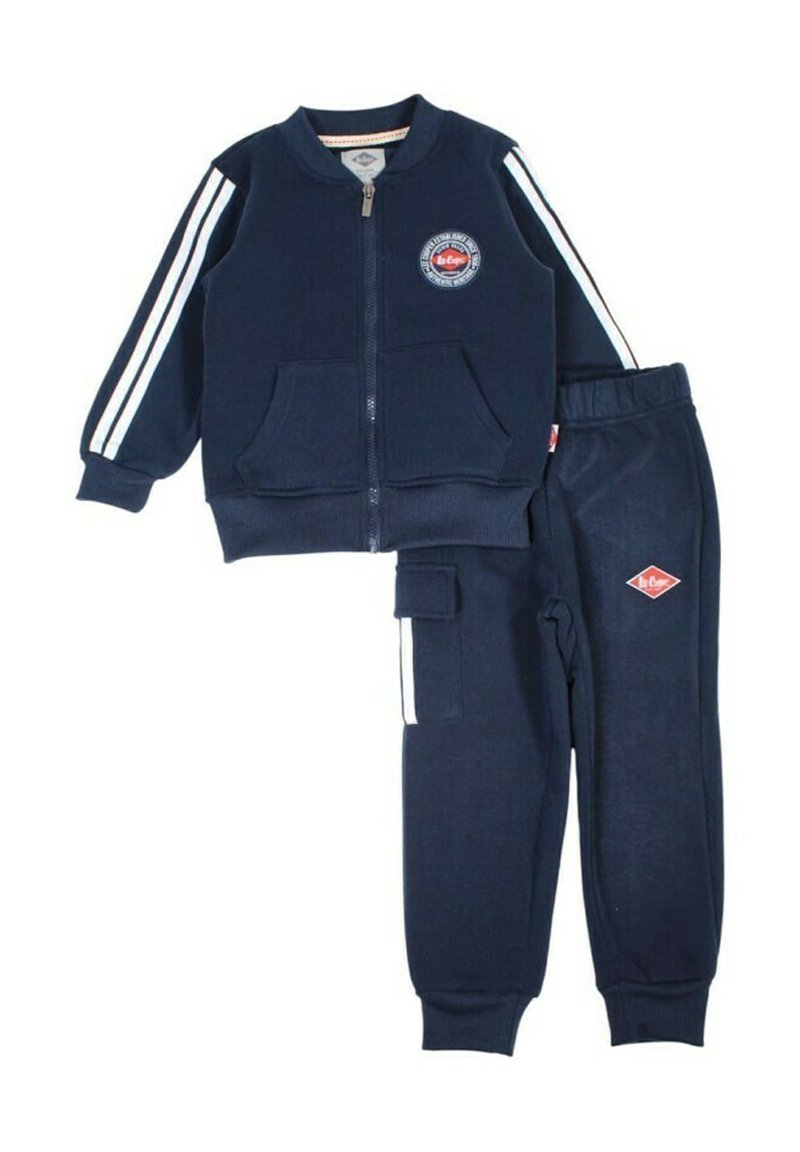 Survêtement pour enfants bleu marine avec veste zippée, bandes blanches sur les manches, poches avant, et pantalon assorti avec taille élastique et poche latérale.