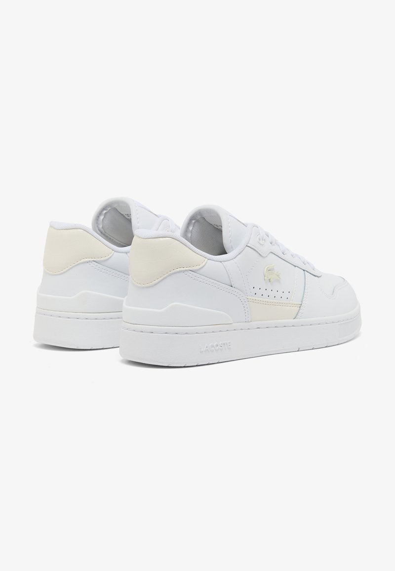 Pair of white low-top sneakers with beige heel accents, perforated side panels, and a subtle crocodile logo on the outer sides.