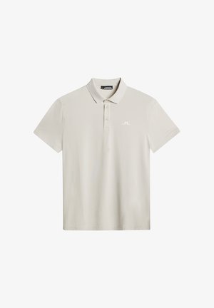 Ljusgrå pikétröja med kort ärm, en klassisk krage och knäppning med tre knappar. Har en diskret vit logotyp på vänster bröst.