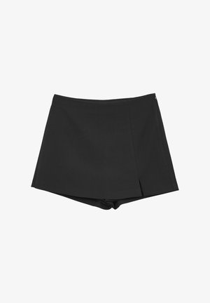 Shorts noirs avec un design à revers, fabriqués en tissu lisse. Avec une fermeture éclair sur le côté et un pli subtil pour une touche de détail supplémentaire.