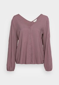 Camisa de manga larga, cuello en V y con botones en color malva. Tejido suave, diseño fluido con mangas gatheradas y una textura sutil.
