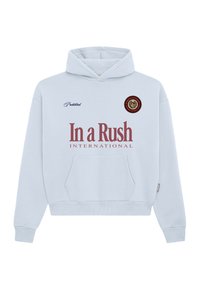 Sweat-shirt à capuche bleu clair avec poche frontale, grand texte « In a Rush International », petit texte « Prohibited » et logo rond sur la poitrine.