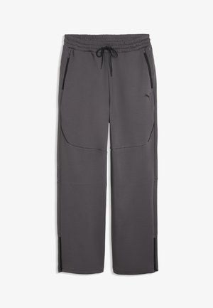 Donkergrijze Puma joggingbroek met elastische tailleband, zwarte trekkoord, ritszakken aan de voorkant en ritssluitingen onderaan de pijpen.
