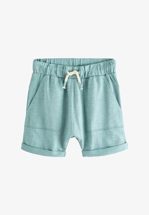 Világoskék pamut rövidnadrág gumis derékkal, krém színű zsinórral és két oldalsó zsebbel. Felgöngyölt szárak és finom textúrájú részletek.