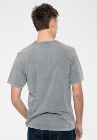 Gray cotton t-shirt with a relaxed fit, short sleeves, crew neckline, and soft texture. No prominent patterns or accents.