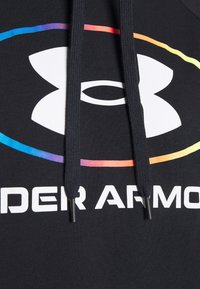 Sweat à capuche noir avec cordons noirs, arborant un logo blanc Under Armour et un fin ovale aux couleurs de l'arc-en-ciel autour du logo.