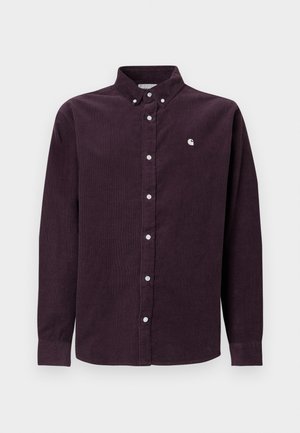 Camicia in velluto a coste di colore viola scuro con colletto abbottonato, bottoni bianchi e logo ricamato sul petto sinistro. Maniche lunghe con polsini abbottonati.
