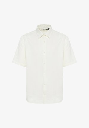 Bela kratka majica s kratkimi rokavi iz lahkotnega, teksturiranega blaga. Ima špicast ovratnik in gumbe spredaj z navadnimi gumbi.