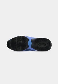 Zila kedu zole ar melnām viļņveida protektora bedrēm un centrālu zilu atbalsta sadaļu, attēlota uz gaiši pelēka fona.