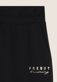 Freddy REGULAR FIT IN CON POLSINI SUL FONDO - Pantalones deportivos - nero