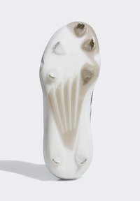 Semelle de chaussure de sport blanche avec une surface lisse, dotée de cinq picots, de rainures profilées et d'un design légèrement surélevé au centre.