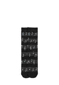 Calcetines negros con un patrón de notas musicales blancas sobre líneas de pentagrama, con acentos en azul claro. Hechos de una tela suave y elástica.