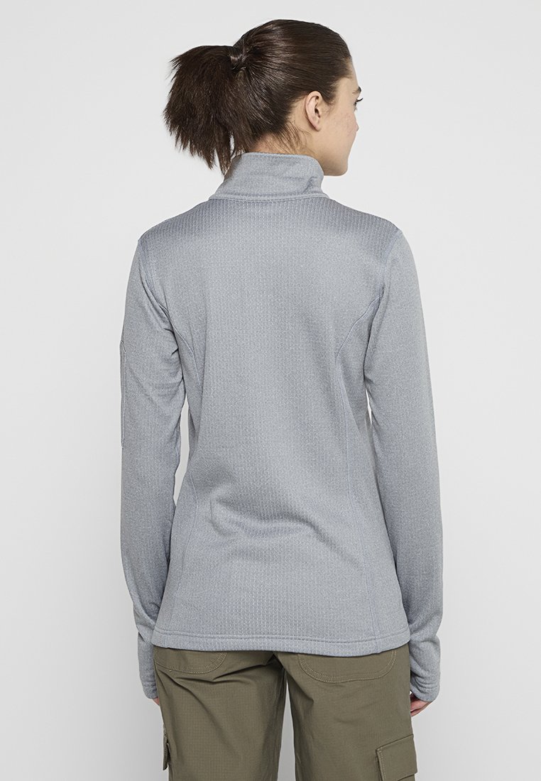 Suéter gris de manga larga con cuello alto, tejido texturizado y diseño ajustado. Presenta costuras planas y se combina con pantalones cargo color oliva.