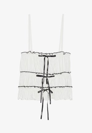 Balta be rankovių palaidinė su pūstomis tekstūromis ir juodais kaspinų akcentais. Yra surinkta medžiaga ir reguliuojamos spageti petnešos.