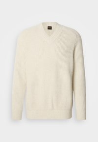 Κρέμα κεντημένο πουλόβερ με V-λαιμό, με ραβδωτή υφή, μακριά μανίκια και χαλαρή εφαρμογή. Ετικέτα λογότυπου ορατή στον λαιμό.