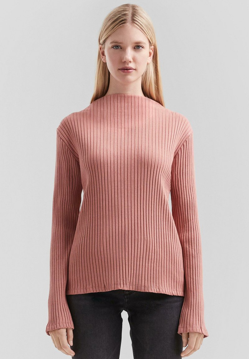 Rippenoberteil mit langen Ärmeln in sanftem Rosa, mit hohem Kragen und ausgestellten Manschetten, aus einem dehnbaren Stoff mit glatter Textur.