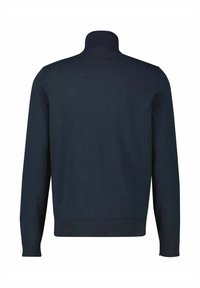 Granatowy, prążkowany sweter z golfem o długich rękawach. Posiada jednolitą, dzianą teksturę i dopasowany fason. Bez dodatkowych wzorów ani ozdób.