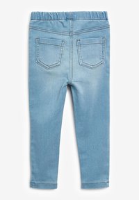 Világoskék farmer leggings, elasztikus derékkal, két hátsó zsebbel és sima, rugalmas textúrával.