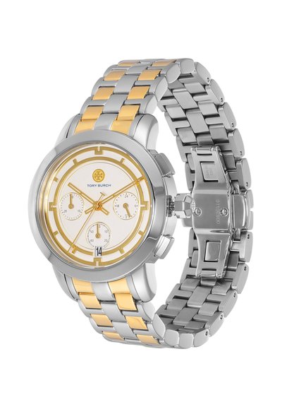 Reloj de pulsera Tory Burch bicolor plateado y dorado con esfera blanca, tres subesferas, pantalla de fecha y pulsera metálica enlazada.