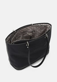 Black tote bag with two handles, zipper pouch inside, and beige lining printed with repeated "Juicy Couture" text in black.